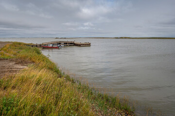 Dock and fishing boat on the Arctic Ocean at Tuktoyaktuk, Northwest Territories, Canada