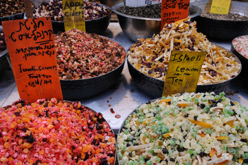 Colorful bins of specialty fruit tea blends.