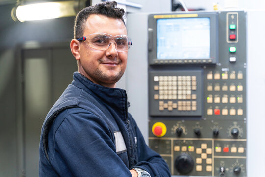 Professional lathe worker man working with milling machine in factory