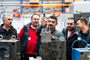 Males Industrial Engineers in Discuss New Project or planning investment project working and strategy. business making conversation at Industrial injection molding factory concept.