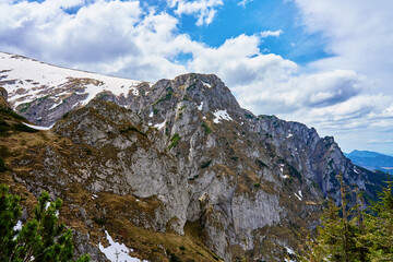 Obraz premium Rugged mountain slope with rocky cliffs and patches of snow. Tatra National Park in Poland. Natural landscape