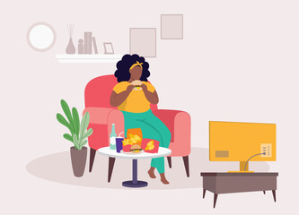 Overweight Black Woman Eating Unhealthy Food While Watching TV. Binge Eating.