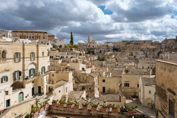 Breathtaking view of Matera, Italy, with ancient stone houses under dramatic clouds