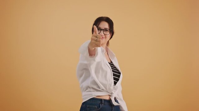 Confident woman joyfully posing with thumbs-up positive sign about right choice