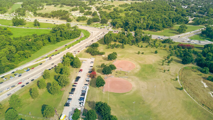 Crowded cars park on street along North Buckner Boulevard and Northwest Highway Dallas near lush...