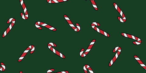 Candy canes on green seamless pattern, doodle style vector