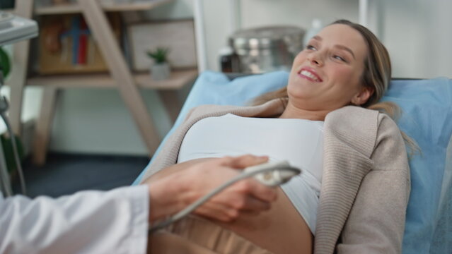 Pregnant woman visiting screening at clinic closeup. Happy expectant mother