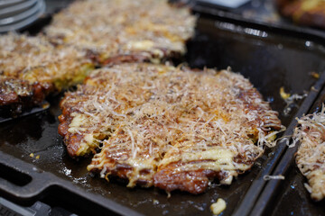 Okonomiyaki is a type of teppanyaki made with a variety of batters and toppings throughout Japan