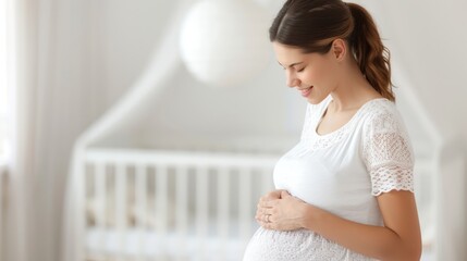 A serene moment of a pregnant woman smiling while cradling her baby bump in a softly lit nursery.