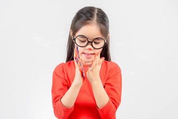 Little girl with hands painted in colorful paint.