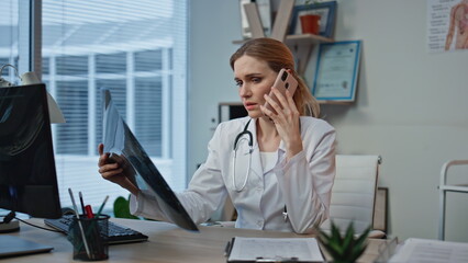 Calling therapist discussing diagnosis closeup. Upset woman examining x-ray