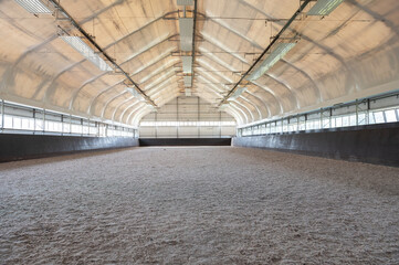 Empty horse riding arena indoor without people