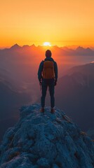 Fototapeta premium Solitary Hiker at Sunset, a lone figure atop a peak, golden sun setting behind majestic mountains, creating a serene and adventurous atmosphere.