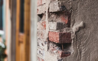Brick wall texture. Close-up shot of an old brick wall with weathered mortar, showing signs of age and decay. The texture is rough and uneven, evoking a sense of history and resilience.