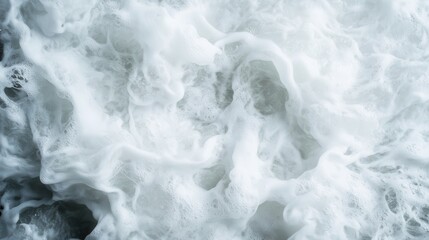 An abstract capture of dynamic white foamy waves, showcasing the natural power and fluidity of water as it creates ever-changing shapes and textures.