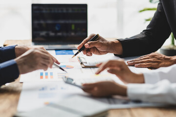 Businessman meeting with consultants discussing data analysis, charts and graphs in financial reports to plan investments and increase company profits.