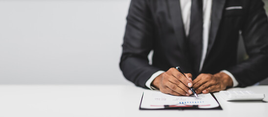 Businessman is reading a business report, analyzing numbers and planning finances.