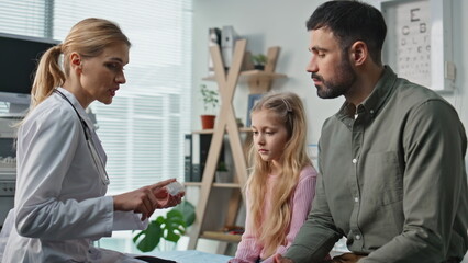 Clinic practitioner giving prescription during appointment. Closeup doctor talk