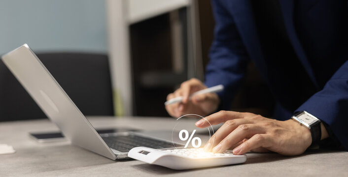 close up manager businessman hand press on calculator to calculate about commission rate form company's project after deal with client in office room for business lifestyle concept