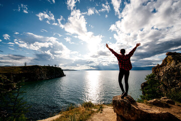a girl on the shore of Lake Baikal at sunset
