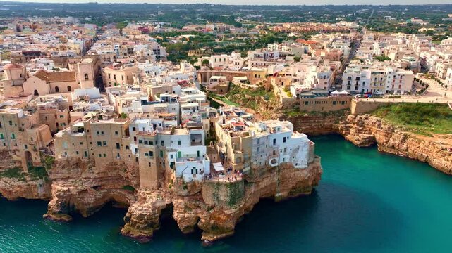 scenic seaside town in southern Italy, Polignano a Mare in Puglia, Italy, aerial view of Italian village of Polignano on the coast of Adriatic Sea, historic traditional touristic town in southern