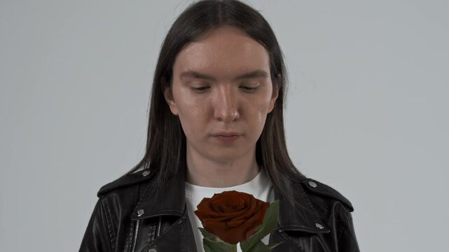 guy holding a red rose flower