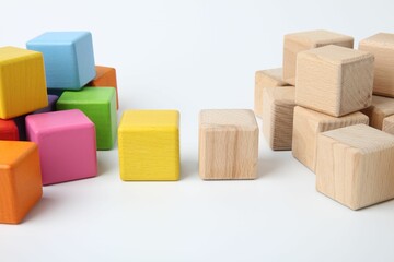 Many wooden colorful cubes on white background