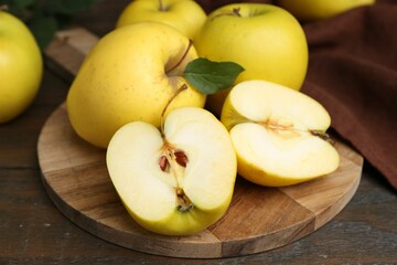 Fresh ripe yellow apples on wooden table, closeup