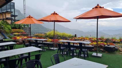 Scenic Outdoor Dining with Mountain Views and Vibrant Flower Beds