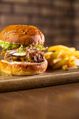 A classic burger served with a side of fries and dipping sauce, showcasing a delicious and indulgent meal. Perfect for themes of fast food, casual dining, and comfort food cravings