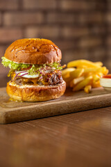 A classic burger served with a side of fries and dipping sauce, showcasing a delicious and indulgent meal. Perfect for themes of fast food, casual dining, and comfort food cravings