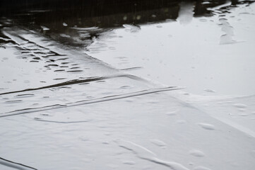 Wet surface of a black rooftop during heavy rain in Brussels, Belgium