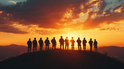 Fototapeta premium Silhouettes of a group of people enjoying a vibrant sunset over a vast mountain landscape