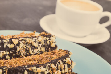 Fresh baked pastry made of zucchini and cup of white coffee. Delicious dessert. Vintage photo