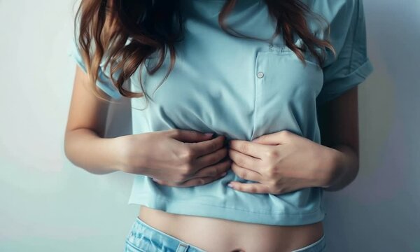 Person with stomach pain on a white background, stomachache, Abdomen bloating concept