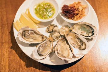 Delicious oysters served on a plate with garnishes, perfect for seafood lovers and culinary enthusiasts.