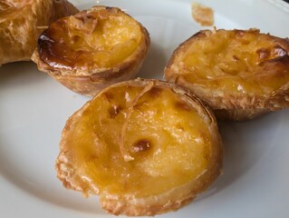 Closeup shot of a plat full of traditional Portugese Pastel de nata