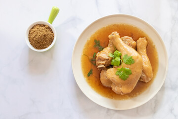 Delicious poached chicken served with savory broth and garnished with cilantro, perfect for a healthy meal.