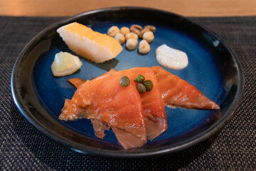 A beautifully arranged plate featuring smoked salmon with garnishes, perfect for food photography and culinary art.