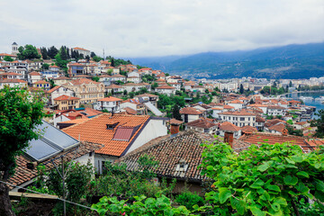 Fototapeta premium Vibrant overview of Ohrid Macedonia showcasing terracotta rooftops and lush greenery under cloudy skies