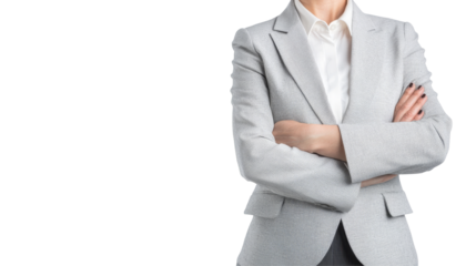 A professional woman in a stylish blazer poses confidently, arms crossed against a plain black background, giving a powerful impression.
