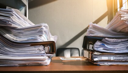 overwhelmed office desk with piles of papers