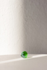 Glass colored balls on a white background. long shadow and refraction patterns. Abstract background. Shallow depth of field (DOF)