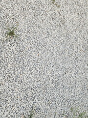 Gray stone background. The walkway is paved with stones for easy walking. Gray gravels for paving walkways surface background. Rough surface paved with grey stones.
