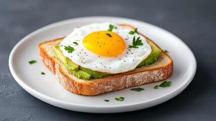 Delicious avocado toast topped with a sunny-side-up egg