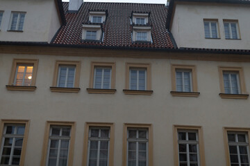 An impressive architectural facade showcases intricately designed windows along with a truly unique rooftop structure