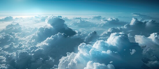 Naklejka premium Aerial view captures white billowing clouds rising beneath dark blue skies with a sharp contrast creating an impressive copy space image