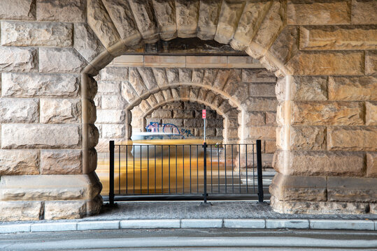 Sandstone arches at Eddy Ave, Central Station with blurry cars driving past