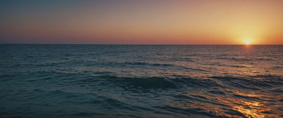 Obraz premium A serene sunset over calm ocean waters, highlighting tranquil waves at dusk