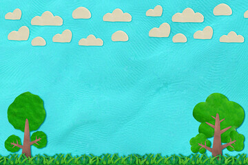 green grass and blue sky with cloud and tree made from plasticine art